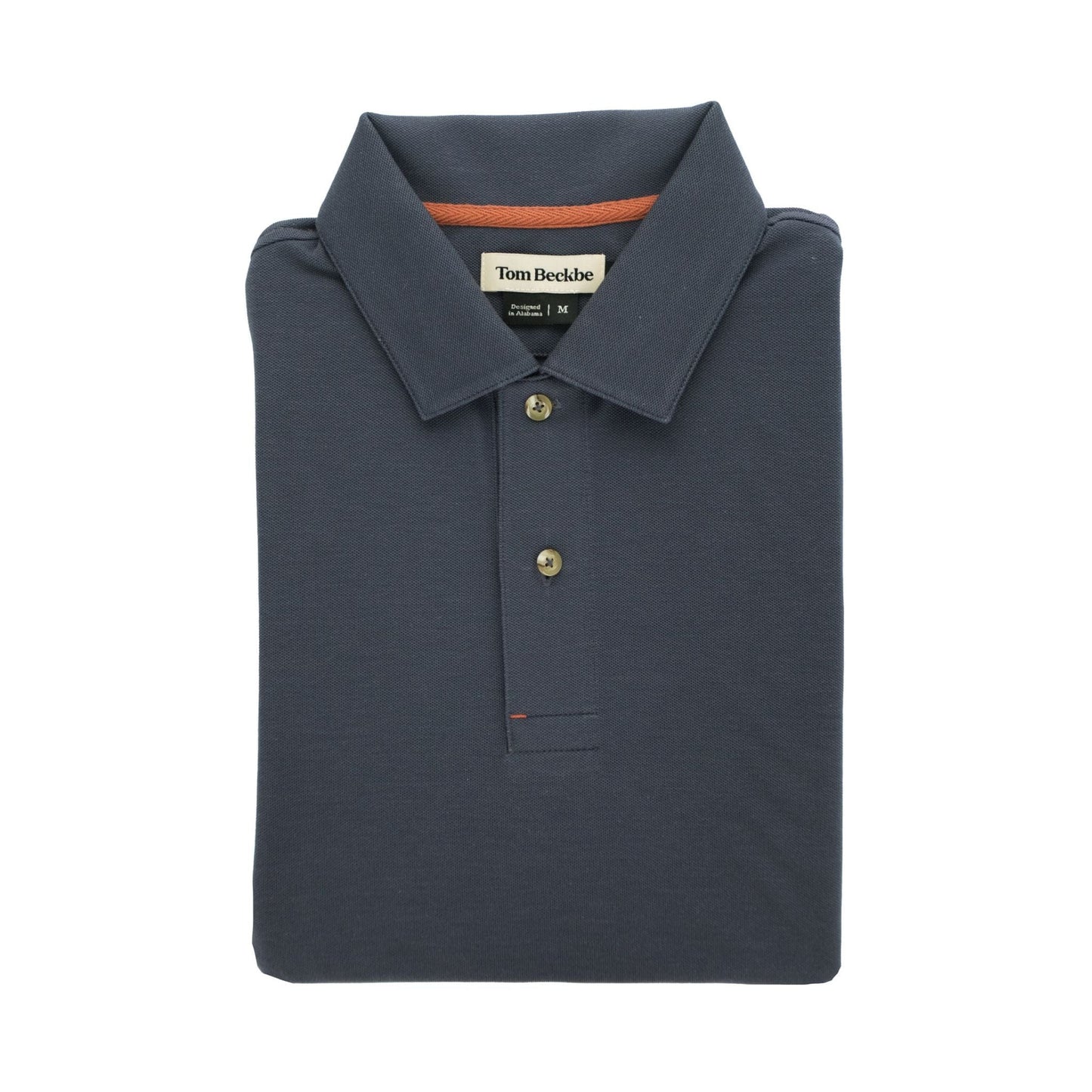 The Coastal Polo Shirt by Tom Beckbe is a classic mens navy polo with a folded collar and buttons, neatly displayed.