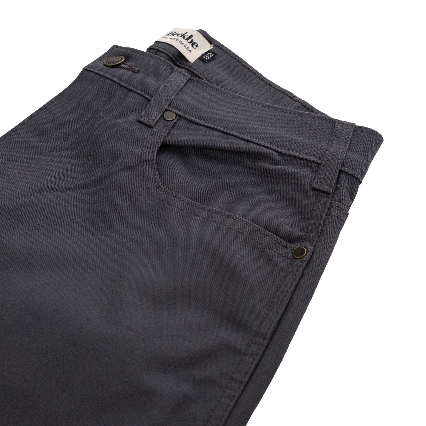 Tom Beckbes Redmont Pant: Mens dark gray durable cotton pants with pockets, a zipper fly, and a logo waistband tag.