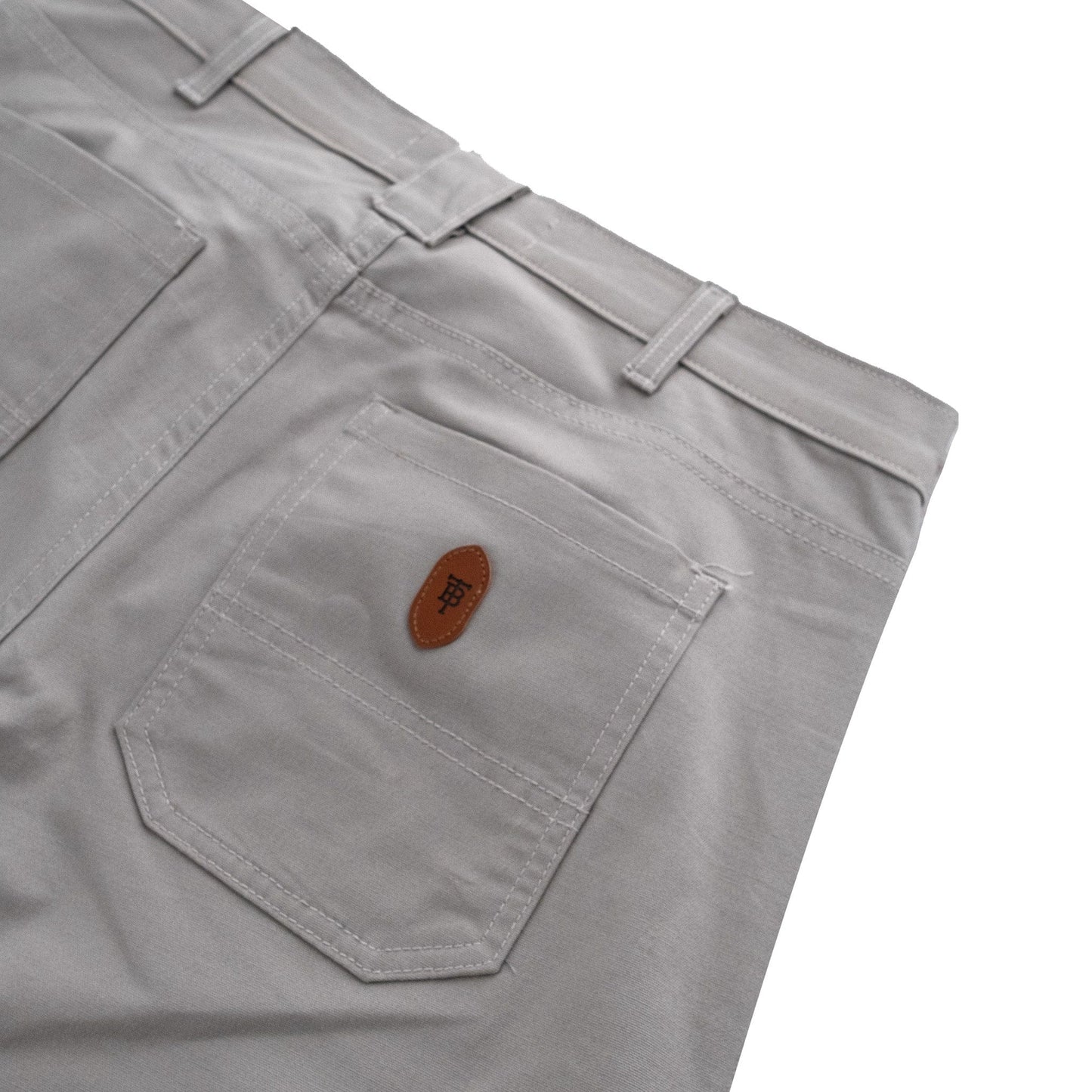 Tom Beckbes durable cotton Redmont Pant for men features a visible back pocket, belt loops, and brown patch detail.