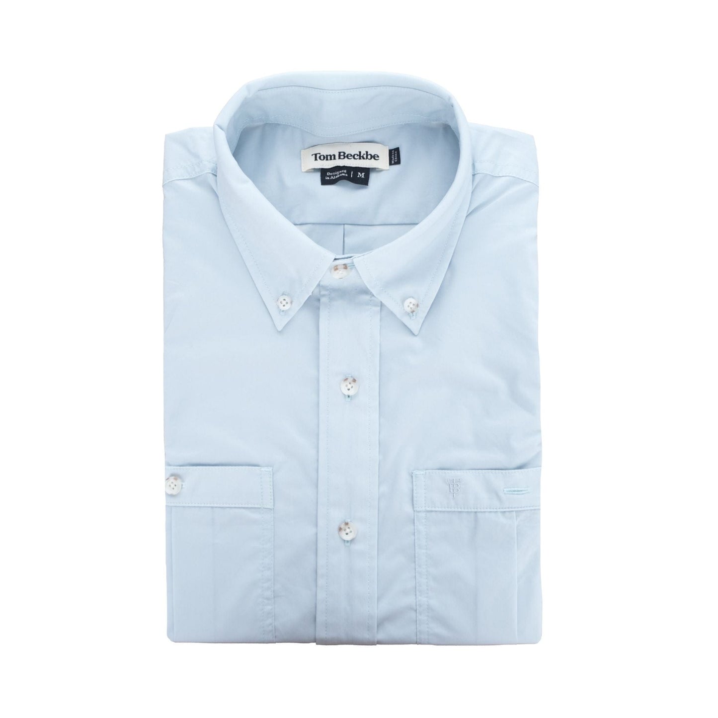 Tom Beckbes Tidewater Shirt: Light blue button-up with front pocket, buttoned collar, UPF 30+ and small tag inside.