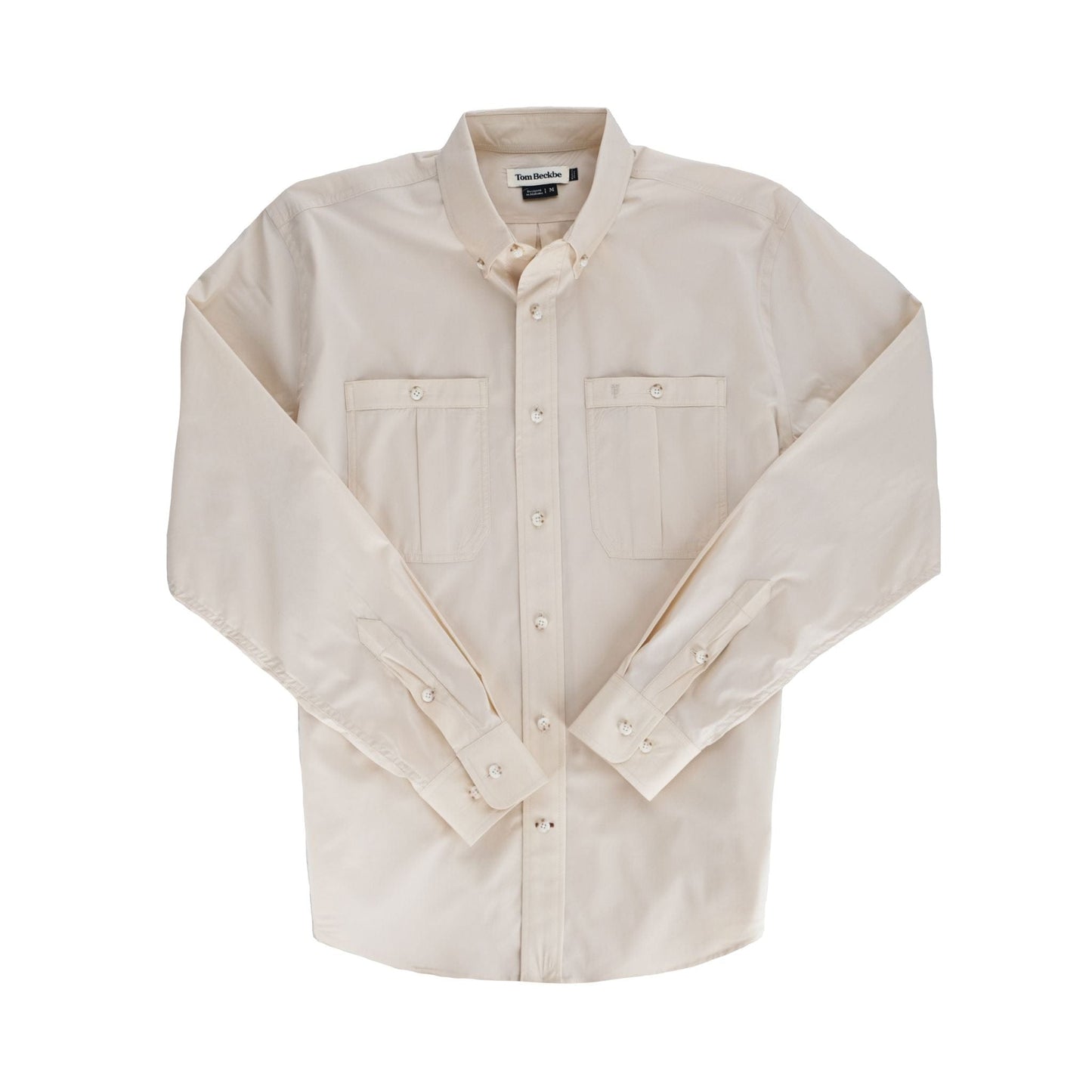 A beige Tom Beckbe Tidewater Shirt, UPF 30+, with two chest pockets, laid flat on a white background.
