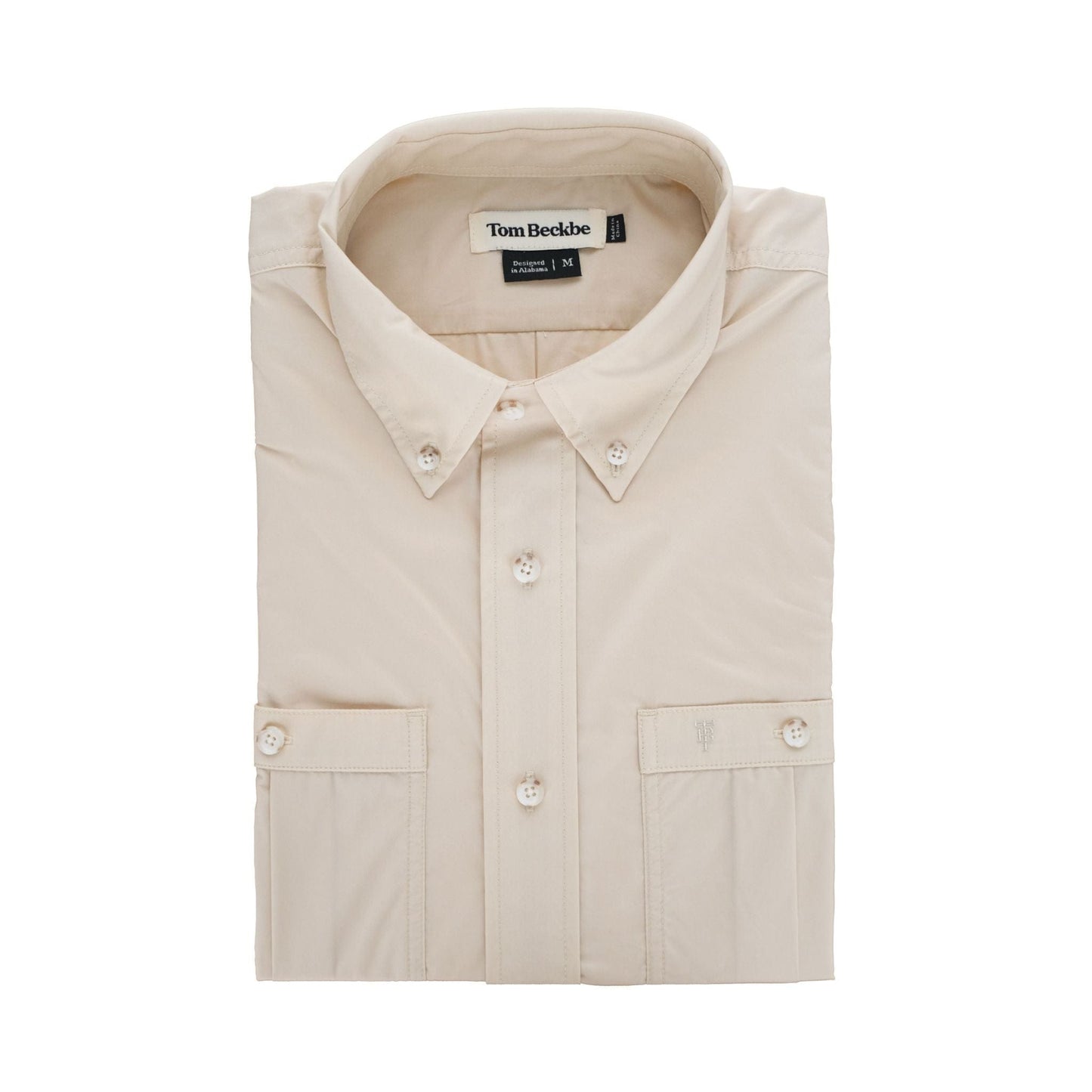 The Tidewater Shirt by Tom Beckbe is a lightweight beige button-up with UPF 30+, a button-down collar, and brand label inside.