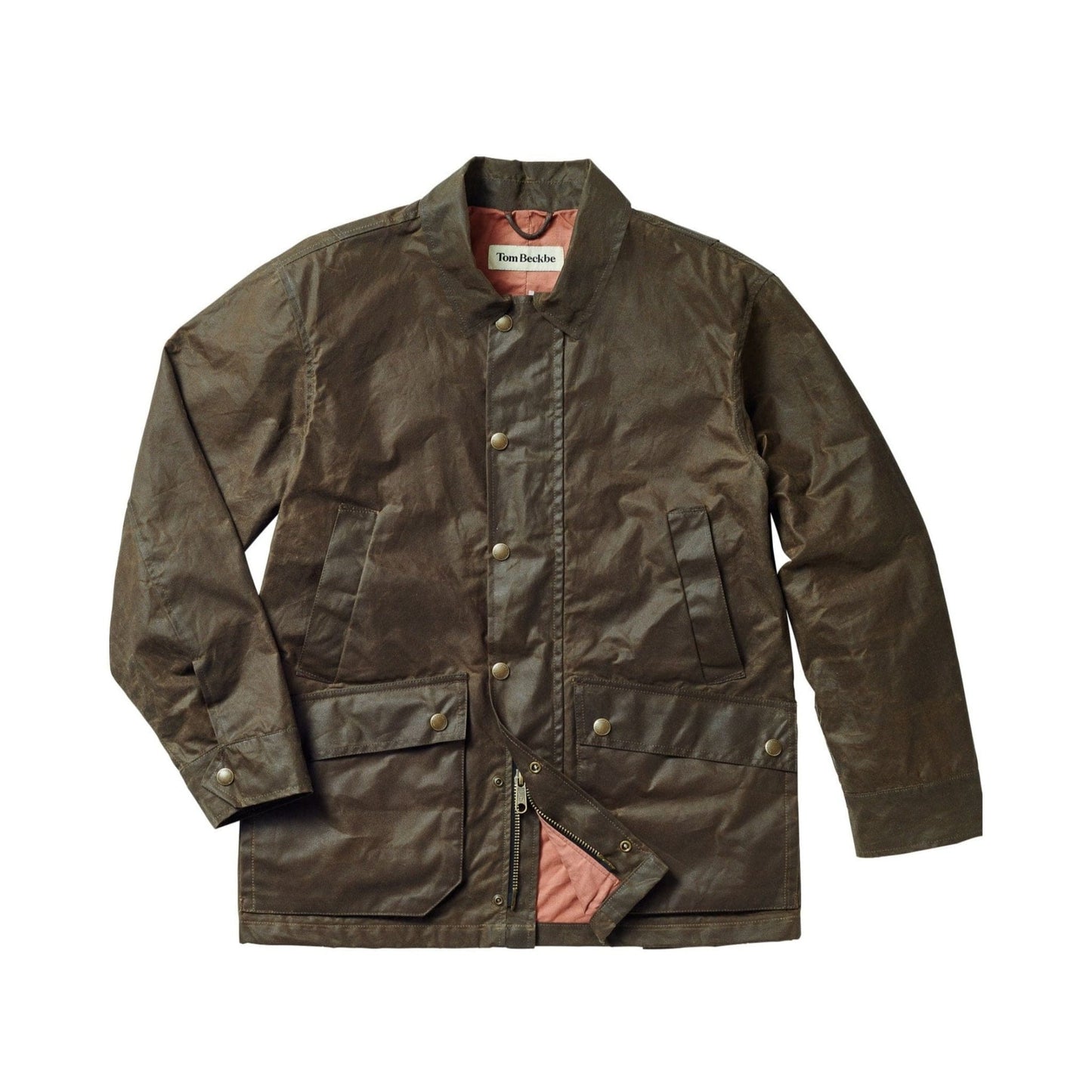 The Piedmont Jacket by Tom Beckbe is a waxed, weatherproof jacket in dark olive with snap buttons, collar, and front pockets.