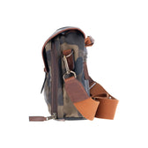 Side view of a Tom Beckbe Classic Camo Blind Bag with leather-bound top and brown adjustable strap on white.