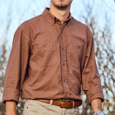 Man wearing Tom Beckbe Dixon Brushed Cotton Twill Shirt, tan pants, and brown belt, standing outdoors.