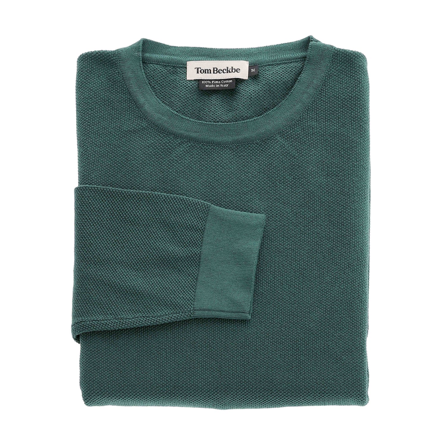 A folded green Foley Pima Crewneck Sweater by Tom Beckbe with the brand label visible on the collar.