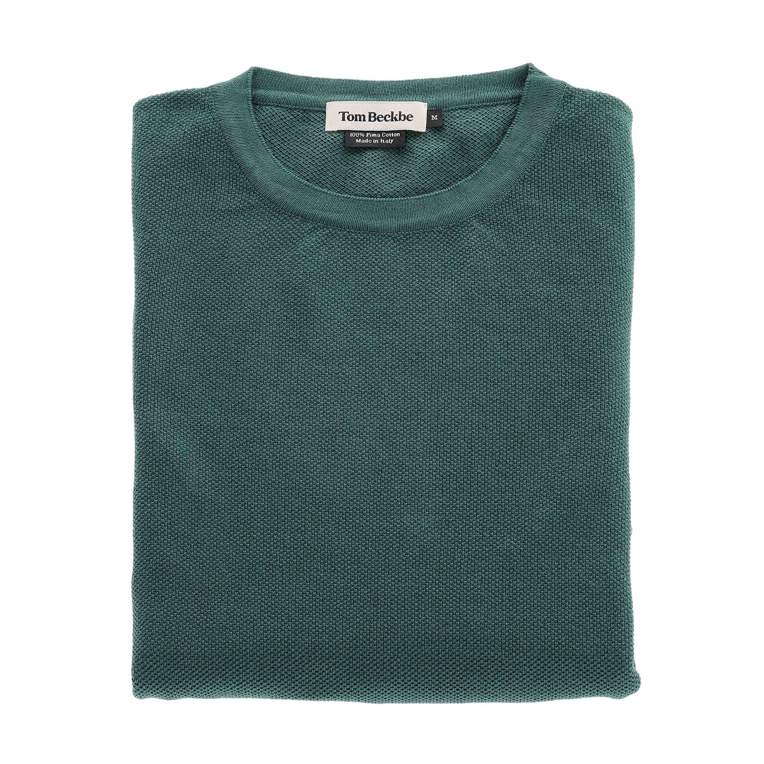 A folded green Foley Pima Crewneck Sweater by Tom Beckbe with the label shown near the collar.