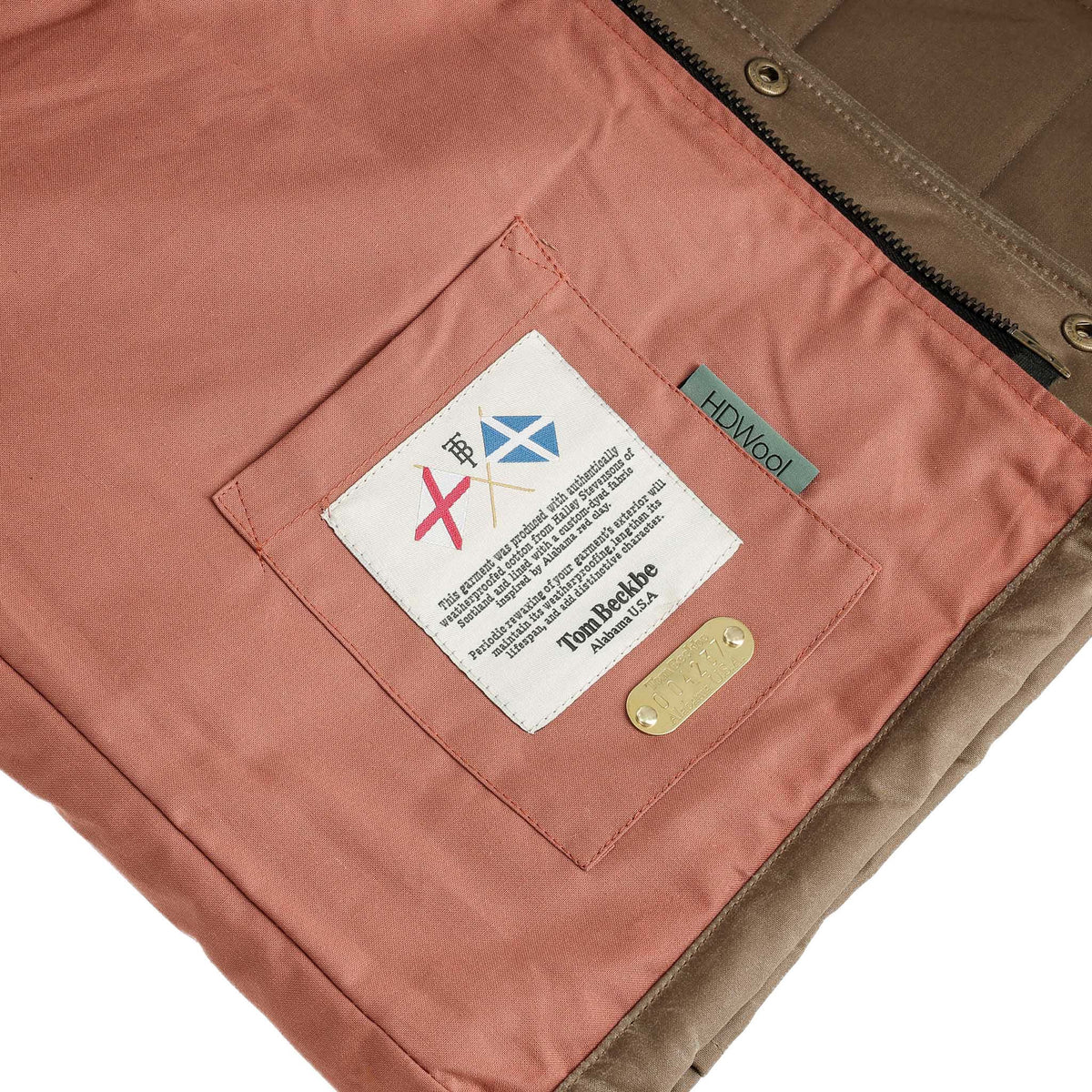 Close-up of Fowler Vest’s interior pocket with multiple tags and an HD Wool insulation label by Tom Beckbe.