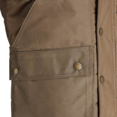Close-up of the Tom Beckbe Fowler Vest pocket with HD Wool insulation, snap buttons, and detailed stitching.