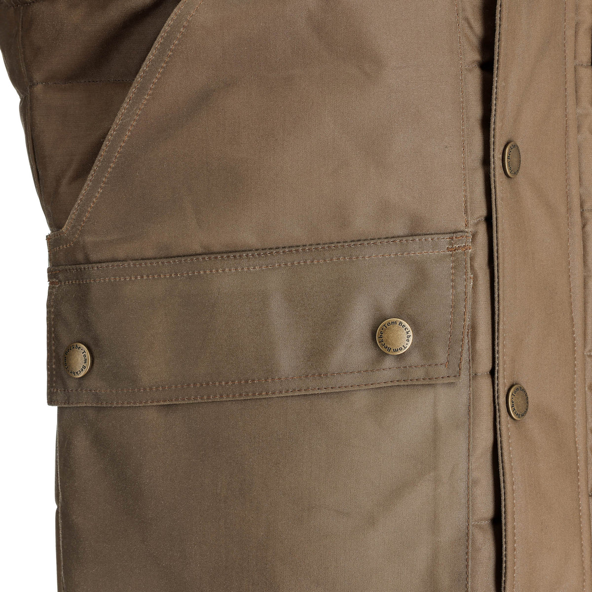 Close-up of the Tom Beckbe Fowler Vest pocket with HD Wool insulation, snap buttons, and detailed stitching.