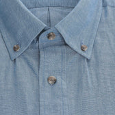Close-up of the Hanover Chambray Shirt collar and placket with three buttons, by Tom Beckbe.