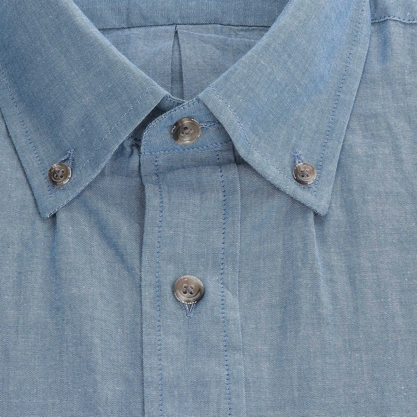 Close-up of the Hanover Chambray Shirt collar and placket with three buttons, by Tom Beckbe.
