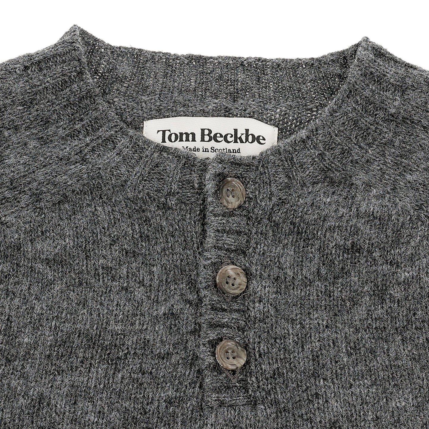 Close-up of Tom Beckbe Albemarle Henley Sweater, gray wool with three buttons, made in Scotland.