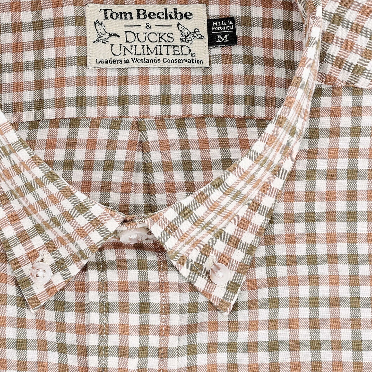 Close-up of Tom Beckbe Knapp Cotton Twill Shirt in brown, green, and white checks with two brand tags at collar.