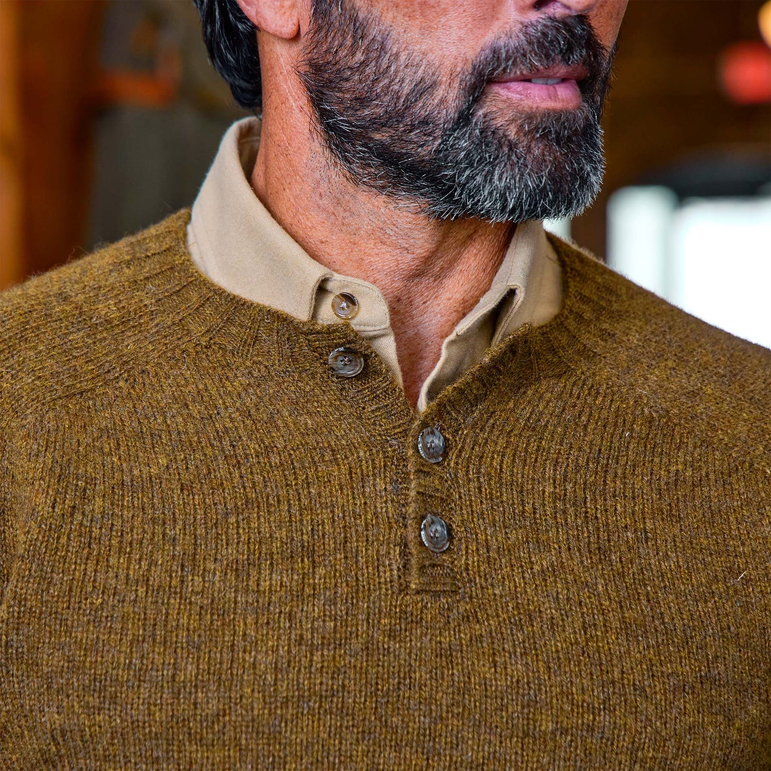 Man wearing the Tom Beckbe Albemarle Henley Sweater, shown from the shoulders up.