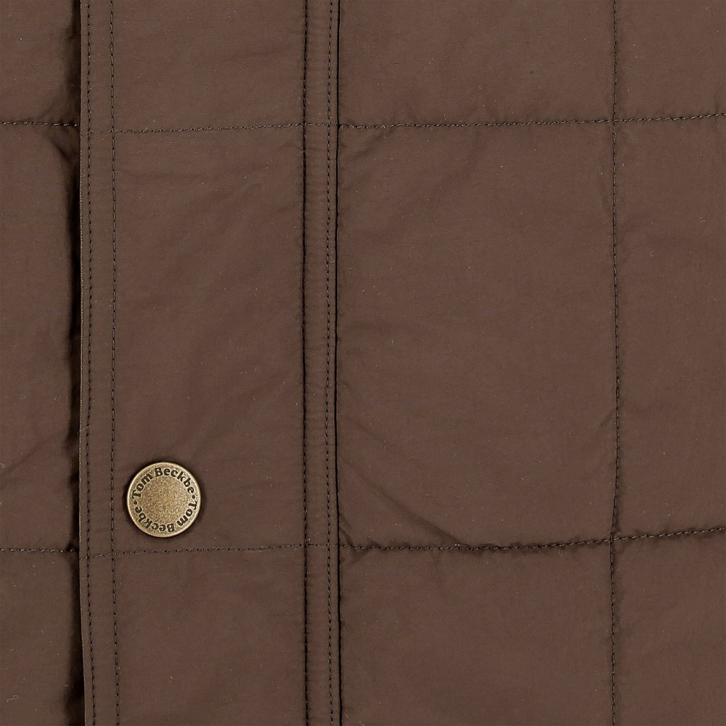 Close-up of the Tom Beckbe Burgess Quilted Vest for men, featuring visible stitched lines and a Loro Piana button.