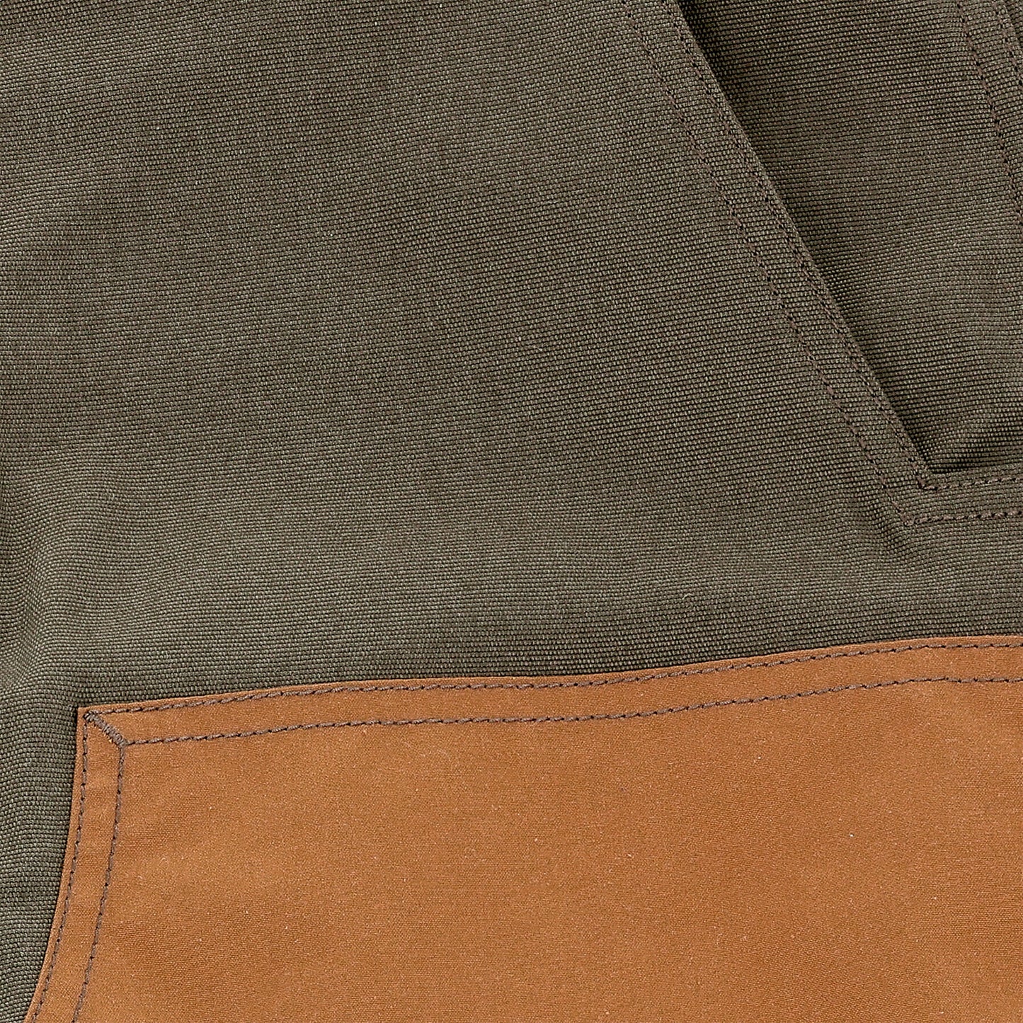 Close-up of Tom Beckbe Burwell Brush Pant in brown waxed canvas with a stitched tan pocket on the lower left side.