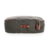 Tom Beckbes Canvas Packing Cube: Green waxed cotton with brown leather accents and dual zippers, ideal for travel.