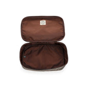 The Tom Beckbe Canvas Packing Cube is a medium brown, zippered rectangular pouch with smooth lining, ideal for travel.
