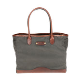 A Tom Beckbe green waxed Canvas Tote with leather handles on a white background.