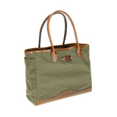 Tom Beckbes Canvas Tote is a durable green waxed canvas bag with brown leather handles, simple design, and sturdy build.