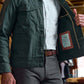 Man wearing the Tom Beckbe Crawford Jacket over a checked shirt, holding it open to display its interior label.
