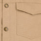 Close-up of the Tom Beckbe Crawford Jacket in beige with a pocket, visible stitching, and metal buttons.