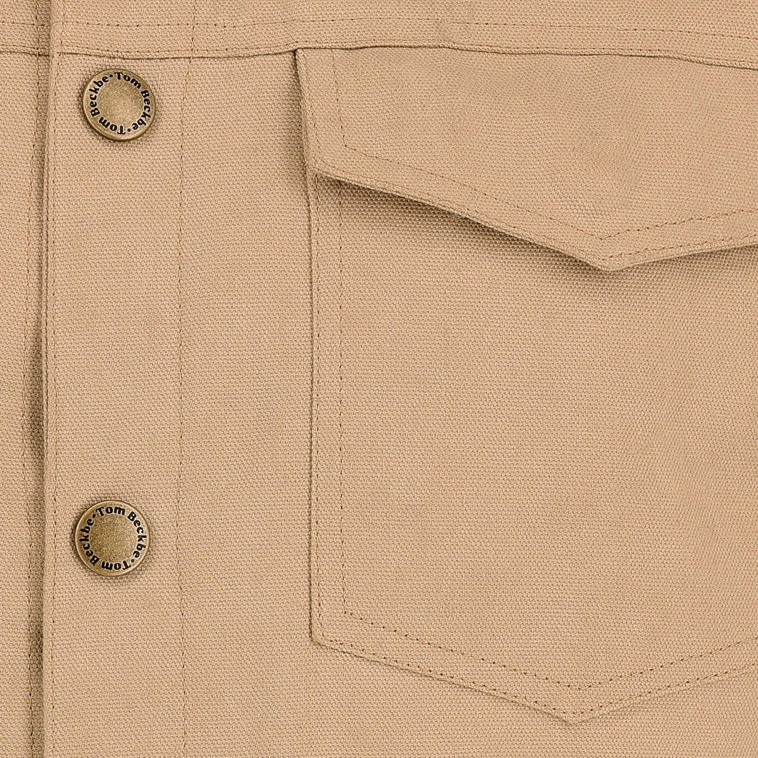 Close-up of the Tom Beckbe Crawford Jacket in beige with a pocket, visible stitching, and metal buttons.