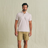 Man facing forward in striped polo and Tom Beckbe Crenshaw Performance Short against plain background, neutral expression.