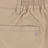 Close-up of Tom Beckbe Crenshaw Performance Short in beige, featuring elastic waistband, belt loop, welt pocket, and logo.