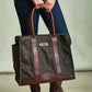 Person holding the Tom Beckbe DU Canvas Carryall, a large olive green tote with brown leather handles.