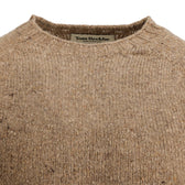 Close-up of a brown Dalton Crewneck Sweater by Tom Beckbe, showing the inner label at the collar.