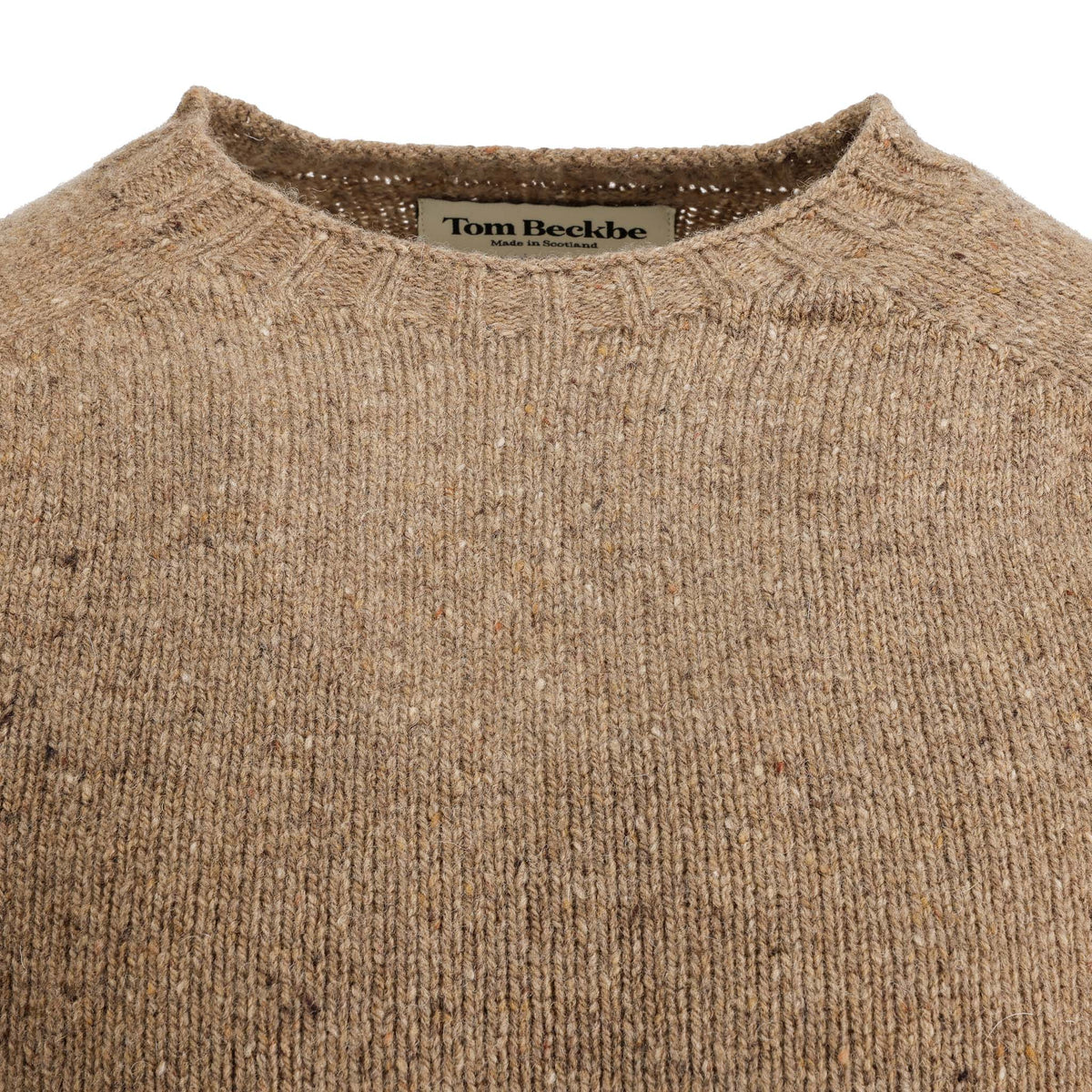 Close-up of a brown Dalton Crewneck Sweater by Tom Beckbe, showing the inner label at the collar.