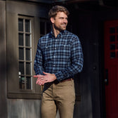 Man wearing a Tom Beckbe Dixon Brushed Cotton Twill Shirt and khaki pants, smiling outside in front of a building.