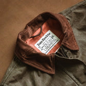 Close-up of the Tom Beckbe Womens Steward Jacket, featuring a corduroy collar and interior branding.