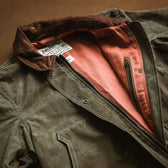 Tom Beckbe Womens Steward Jacket: brown waxed cloth, corduroy collar, red lining, zippered chest pocket.