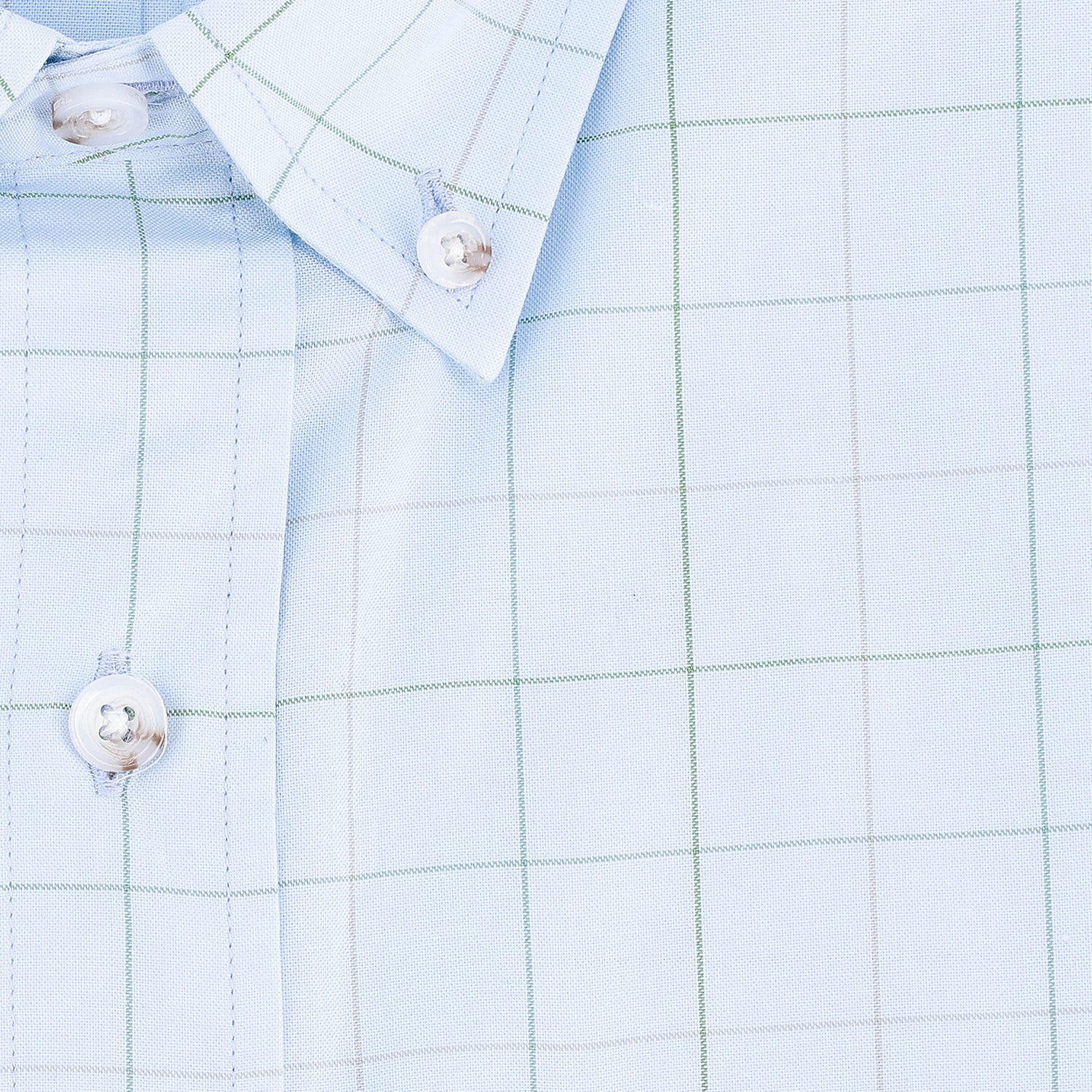 Close-up of the Ensley Pinpoint Oxford Shirt by Tom Beckbe in light blue with green and gray checks and white buttons.