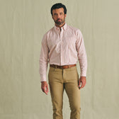 Man in Tom Beckbe Ensley Pinpoint Oxford Shirt, tucked into tan pants with brown belt, against a beige background.