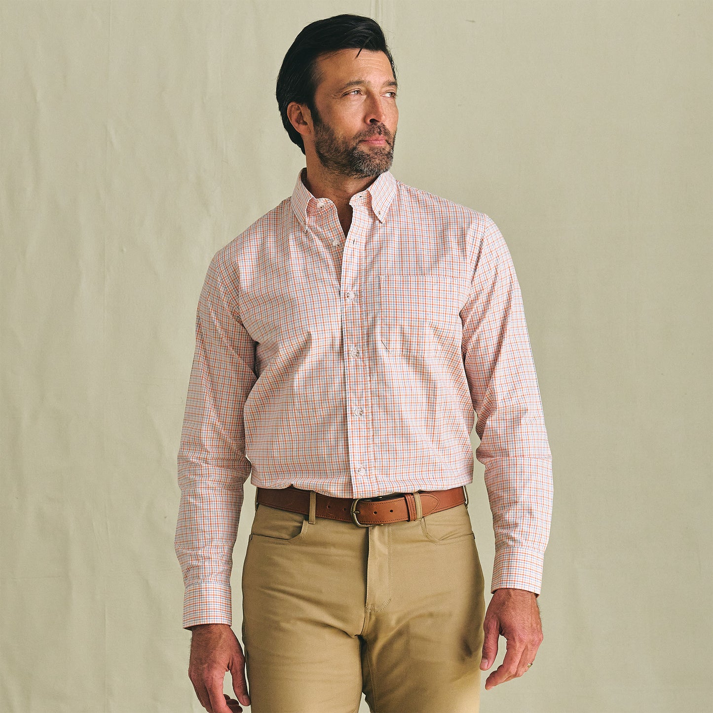 Man wearing Tom Beckbe Ensley Pinpoint Oxford Shirt with tan pants, standing against a plain light background.