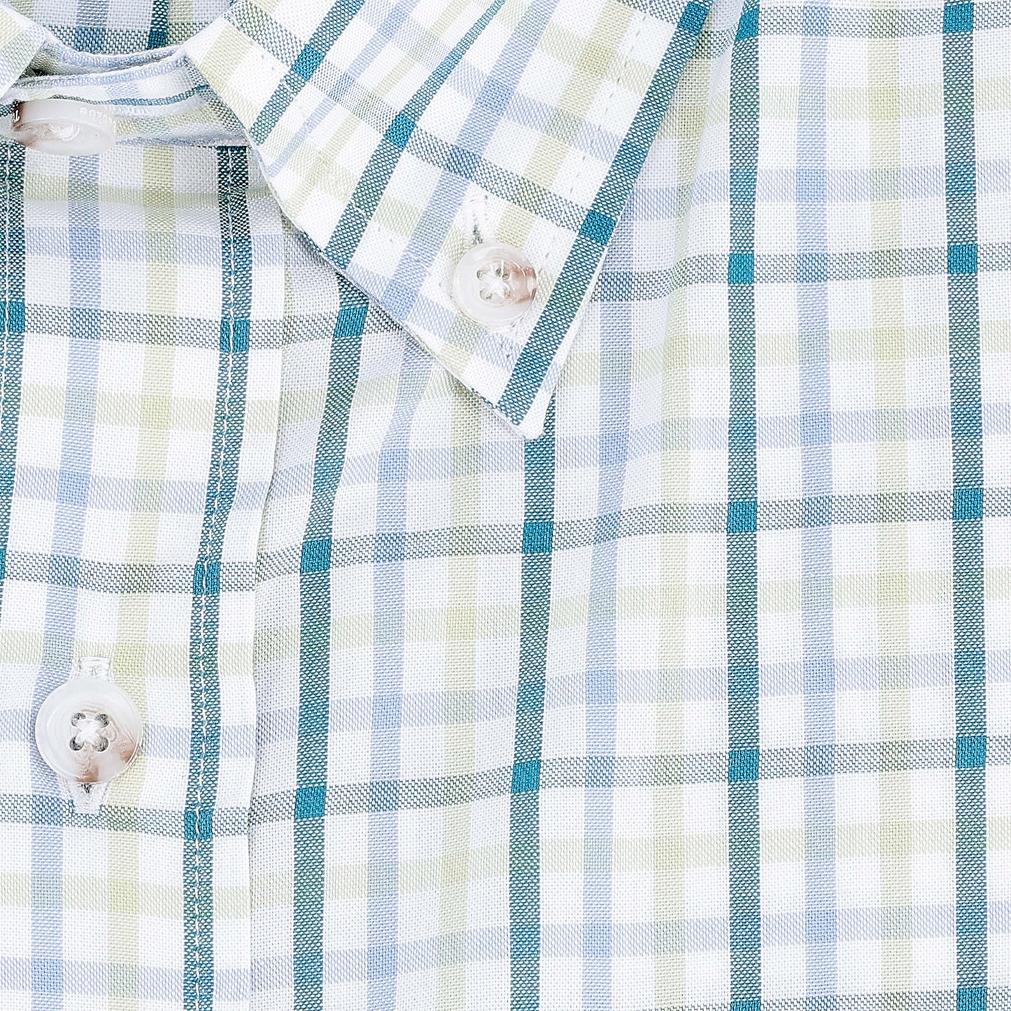 Close-up of the Tom Beckbe Ensley Pinpoint Oxford Shirt in a light blue, green, and white plaid pattern.