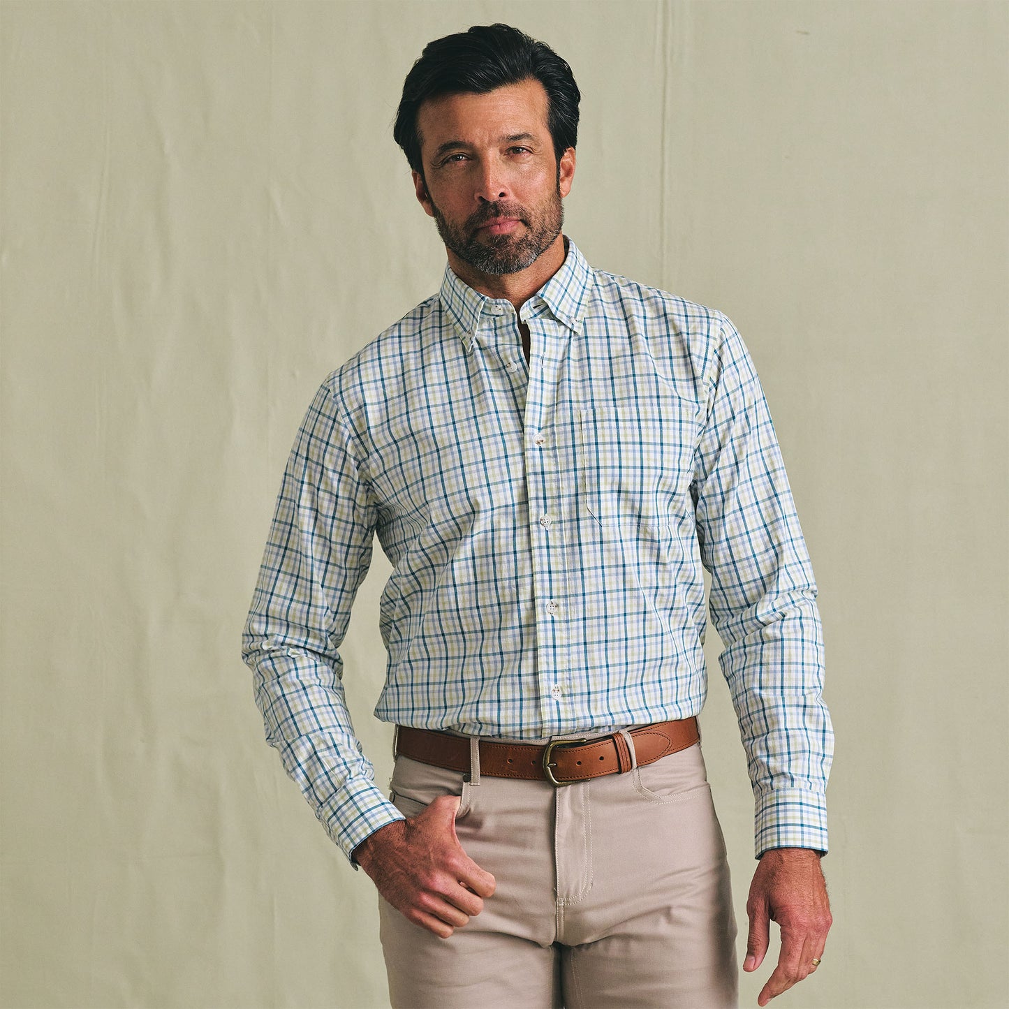 Man wearing the Tom Beckbe Ensley Pinpoint Oxford Shirt with beige pants and a brown belt, against a plain background.