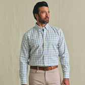 Man wearing the Tom Beckbe Ensley Pinpoint Oxford Shirt and beige pants, standing against a plain light background.