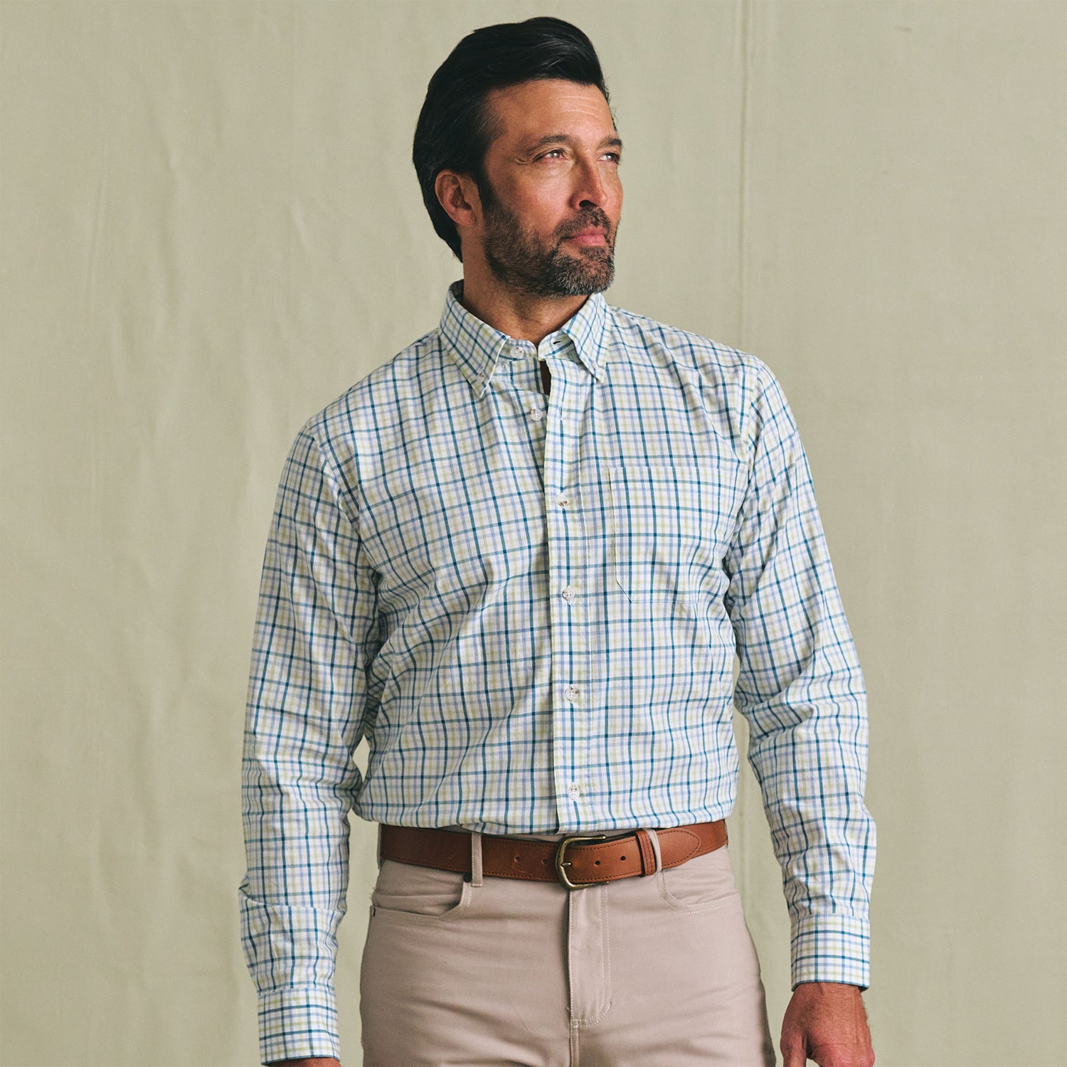 Man wearing the Tom Beckbe Ensley Pinpoint Oxford Shirt and beige pants, standing against a plain light background.