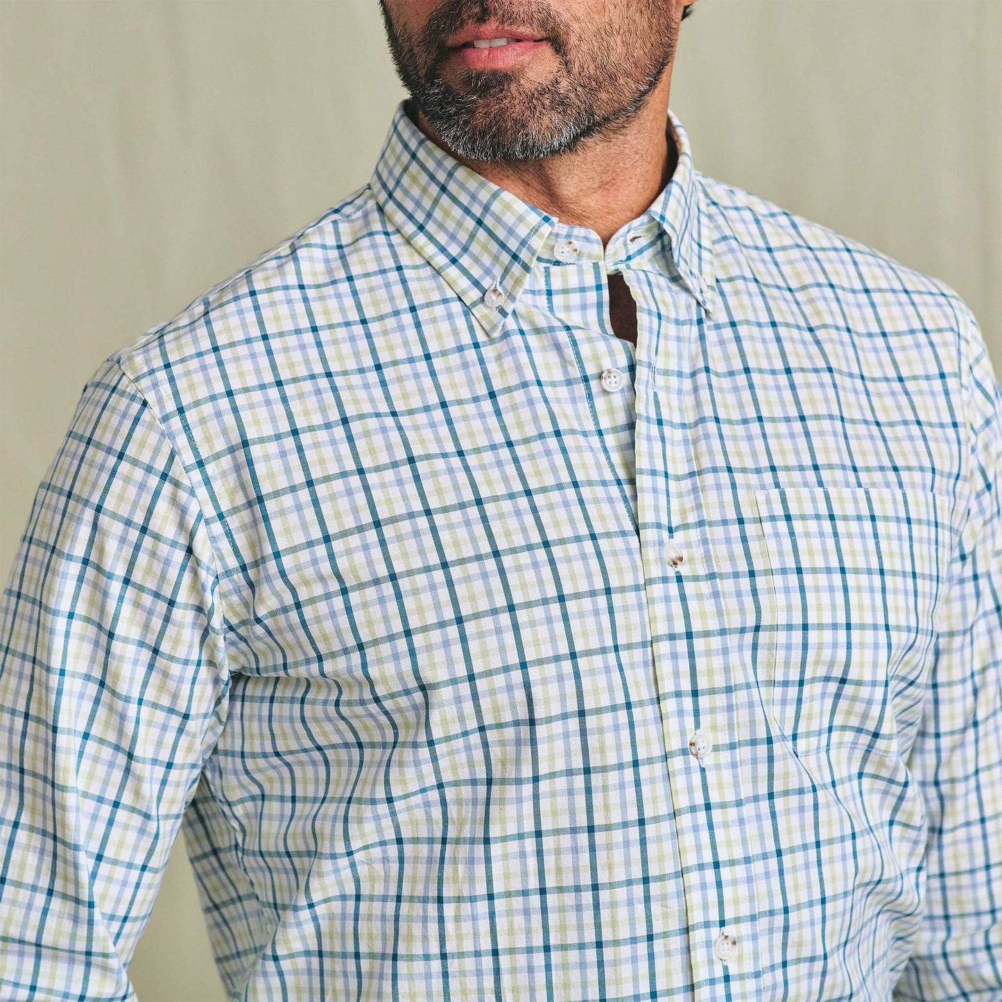 Man in Tom Beckbe Ensley Pinpoint Oxford Shirt, blue and green, shown from shoulders to mid-chest.