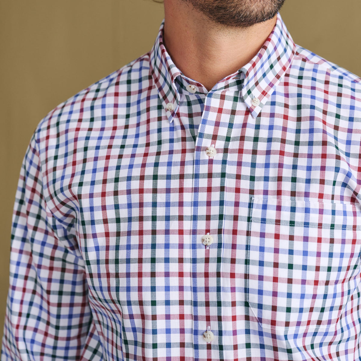 Model wears Tom Beckbe Ensley Pinpoint Oxford Shirt, multicolor check, chest to chin view with pocket visible.