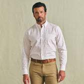 Man in a Tom Beckbe Ensley Pinpoint Oxford Shirt and khaki pants with a brown belt, against a plain background.
