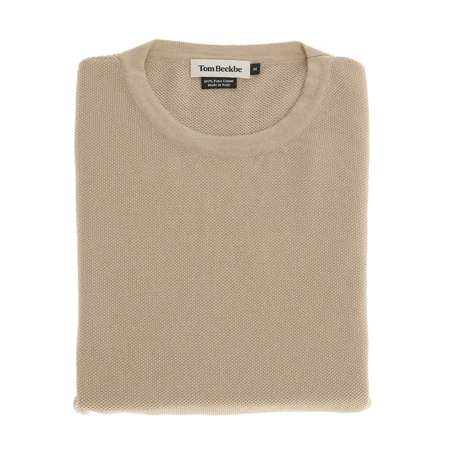 The Tom Beckbe Foley Pima Crewneck Sweater in beige is neatly folded with the label visible on a white background.
