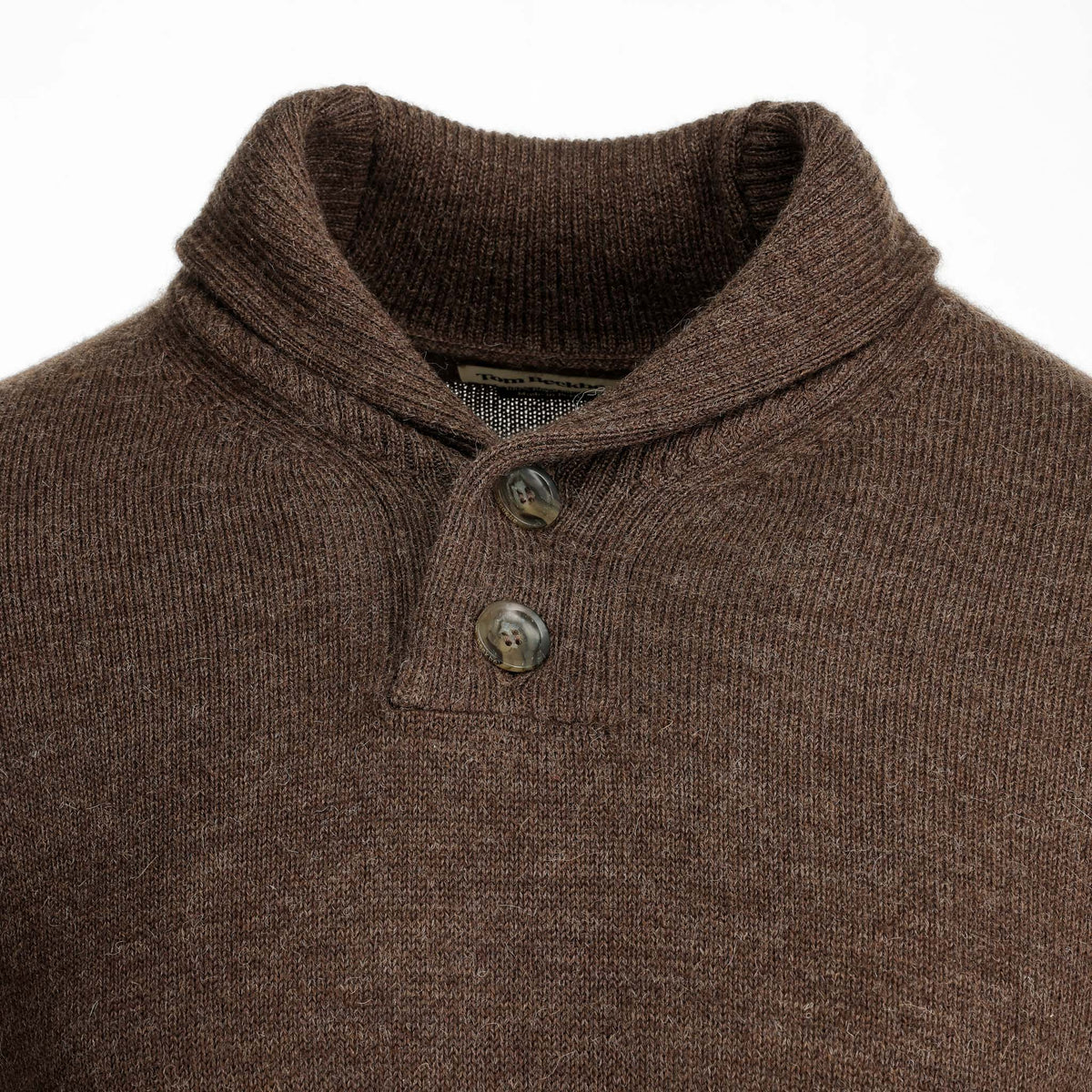 Close-up of Tom Beckbe’s Henry Shawl Sweater in Royal Alpaca, featuring a brown knit and two stylish neck buttons.