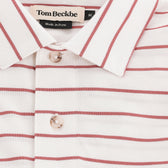 Close-up of the Tom Beckbe Hutton Performance Polo, men's, white with red stripes and buttons, made in Peru.
