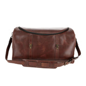 Tom Beckbe Leather Weekender Duffel Bag with shoulder strap, two front buckles, and zippered top shown on white.